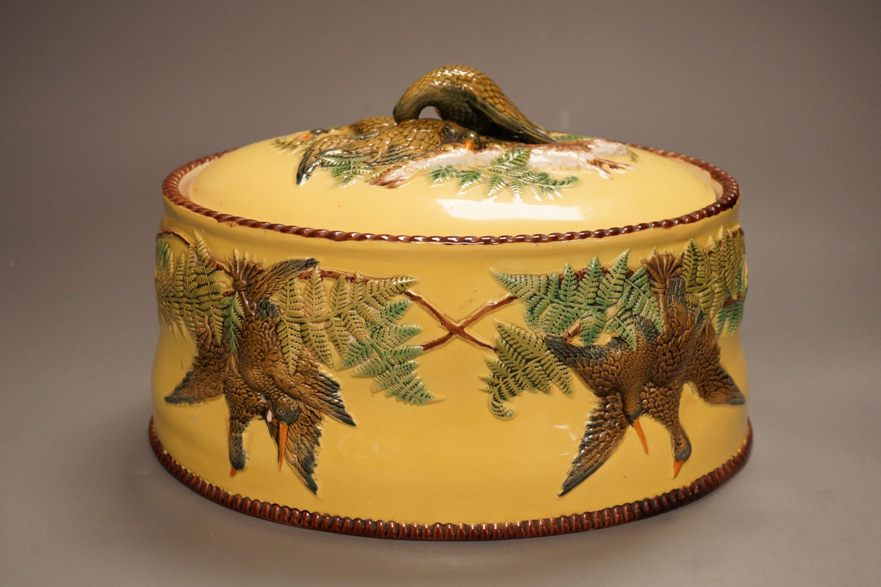 A Continental majolica game tureen with floral and bird relief, 18cm tall